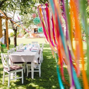 A table set for kids birthday party outdoors in garden in summer.