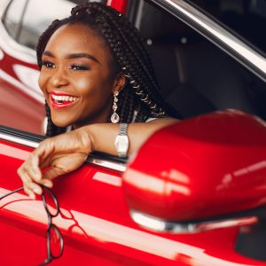 Stylish black woman in a car salon